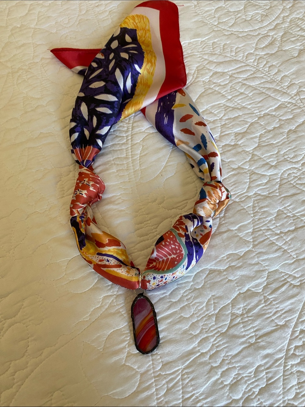 Repurposed handmade glass pendant on a new scarf.